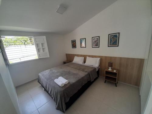 a bedroom with a bed with two towels on it at Casa em Porto de Galinhas in Porto De Galinhas