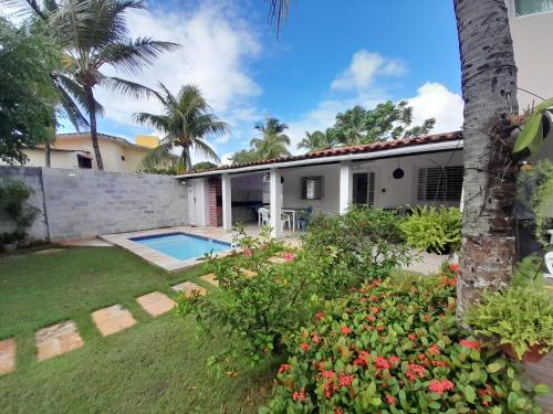 a house with a swimming pool and a yard at Casa em Porto de Galinhas in Porto De Galinhas