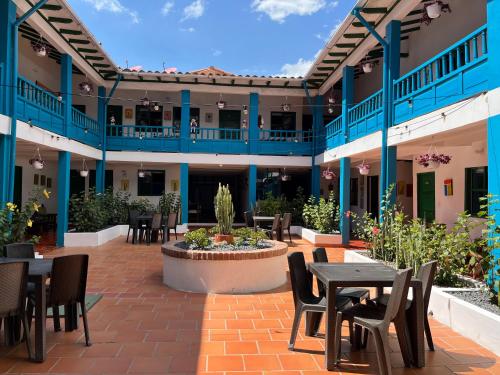 a courtyard with tables and chairs in a building at Celeste Villa de Leyva in Villa de Leyva