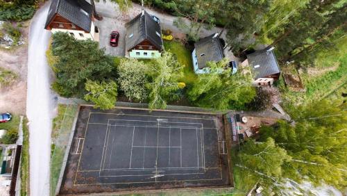an aerial view of a large tennis court in a yard at Chaty Koloděje-modrý dům in Koloděje nad Lužnicí