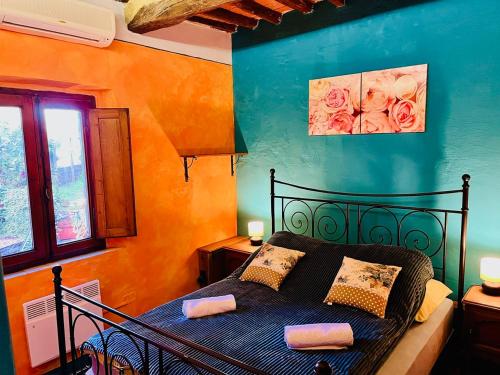 1 dormitorio con 1 cama negra en una habitación en Turquoise Rose Apartment, en Peccioli