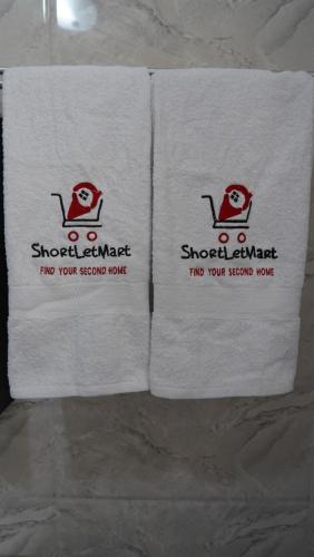 three towels sitting on top of a table at SHORTLETMART Guest House in Lekki