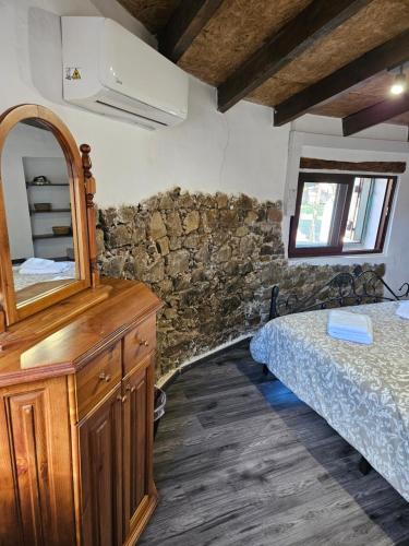 a bedroom with a bed and a dresser and a mirror at Το Αρχοντικό της Ευτυχίας in Nicosia