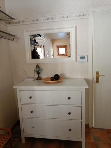 a dresser with a mirror on top of it at Nordic character in Vidsel