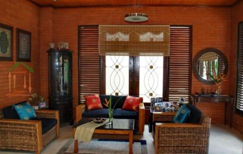 a living room with a couch and a table at Rumah Sudut in Siantan