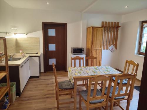 a kitchen and dining room with a table and chairs at Chatky Janis in Liptovský Mikuláš