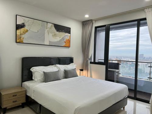 a bedroom with a large bed and a large window at City View Studio Unit in Phnom Penh