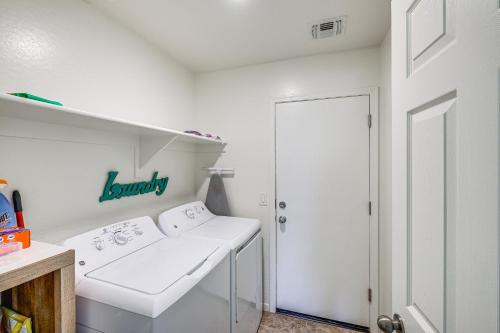 a white laundry room with a washer and dryer at Backyard Oasis Updated San Tan Valley Escape in San Tan Valley