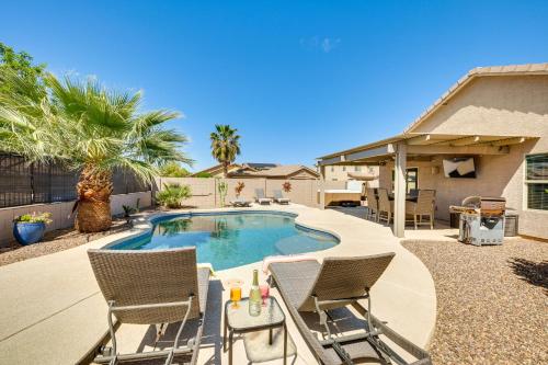a swimming pool with two chairs and a table at Backyard Oasis Updated San Tan Valley Escape in San Tan Valley
