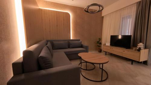 a living room with a couch and a table at Mouson Luxury Suite With Free Private Parking in Kavala