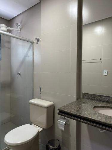 a bathroom with a toilet and a sink at Norte Palace Hotel in São Mateus