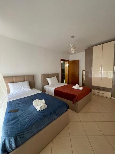 a hotel room with two beds and a bathroom at Angels Apartment in Berat