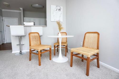 a table and chairs in a room with a table at Comfortable Apartment with Pool Gym & other Amenities #3304 in Woburn