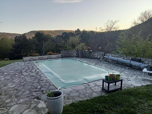 a large swimming pool on a stone patio at AlpesAzur in Coursegoules