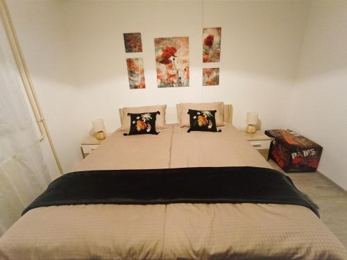 a bedroom with a large bed with two pillows at Apartma Xanadu in Slovenske Konjice