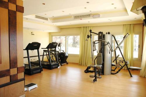 a gym with several tread machines in a room at AIFU Hotel El Montazah Alexandria in Alexandria