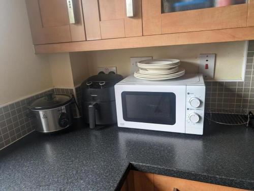 a microwave on a counter in a kitchen at Budget rooms in Dudley in Tipton