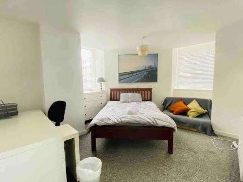 a bedroom with a bed and a couch in it at 2 Bedroom Modern stylish Apt in Glasgow City Centre in Glasgow