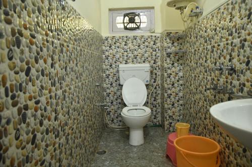 a bathroom with a toilet and a sink at Dingle House , A Heritage House in Dalhousie