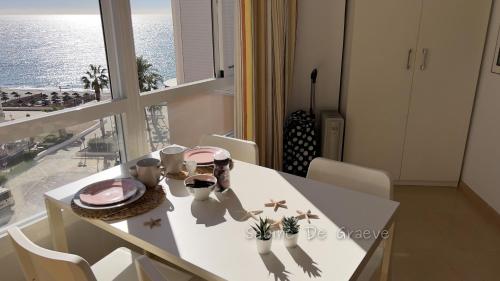 a white dining room table with a view of the ocean at Madrid-M504 in Torrox Costa