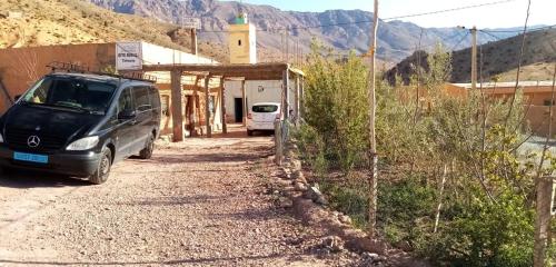 una furgoneta estacionada en un camino de tierra al lado de un edificio en GITE ROURAL TATIOUINE, 