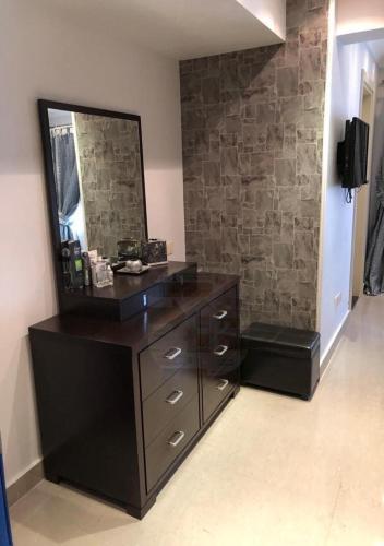 a bathroom with a dresser and a mirror at فيلا بالكامل الساحل مارينا اطلاله فيو البحر in El Alamein