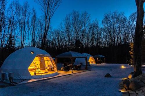 a group of tents in a field at night at NAGOMI CAMP - Vacation STAY 48653v in Nasushiobara