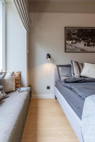 a bedroom with two beds and a window at Monciak Elegance - Plaża by OneApartments in Sopot