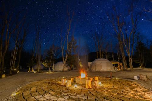 a fire pit in the middle of a field at night at NAGOMI CAMP - Vacation STAY 48654v in Nasushiobara
