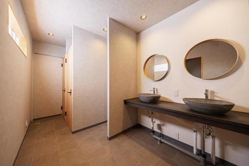 a bathroom with two sinks and two mirrors at NAGOMI CAMP - Vacation STAY 48654v in Nasushiobara