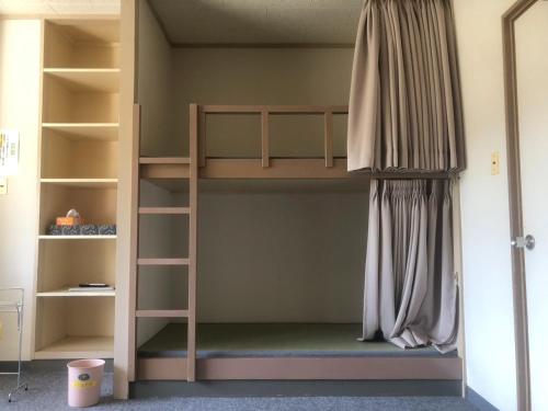 a bunk bed with a ladder in a room at Guesthouse Sunaen - Vacation STAY 49057v in Tottori