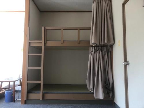 a bunk bed with a ladder in a room at Guesthouse Sunaen - Vacation STAY 49057v in Tottori