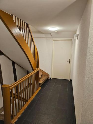 a hallway with a staircase and a white door at City Center Apt. Old Town ZH in Zurich