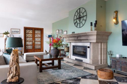 a living room with a couch and a fireplace at Bed & Breakfast Villa Botánica in Málaga