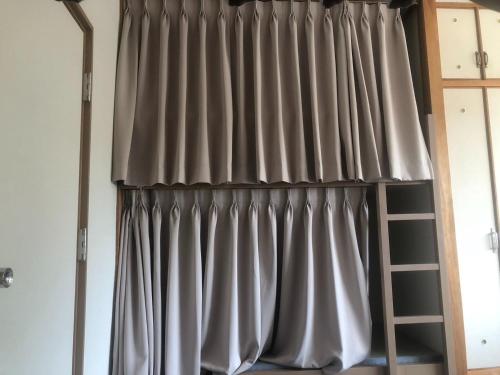 a curtain in a room with a ladder at Guesthouse Sunaen - Vacation STAY 49061v in Tottori