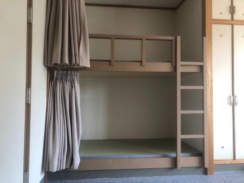 a bunk bed in a room with a window at Guesthouse Sunaen - Vacation STAY 49061v in Tottori