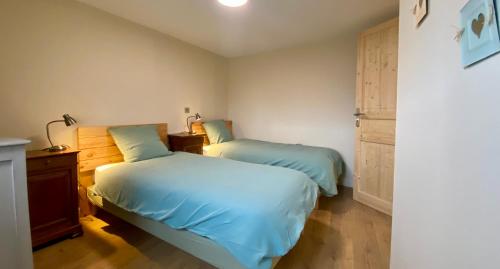 a bedroom with two beds and a dresser at la Crémesine in Baratier