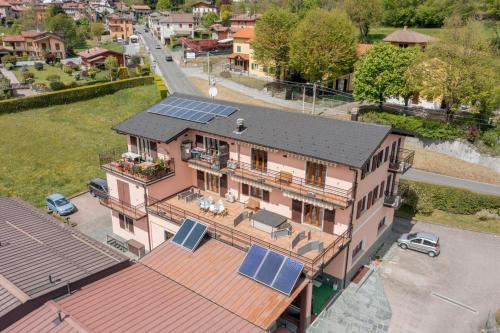 an aerial view of a house with solar panels on its roof at La Terrazza sui Monti in Castiglione dʼIntelvi