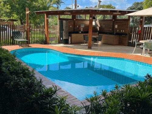 a swimming pool in a backyard with a gazebo at CPR - Apartamentos a 200m da praia com Piscina in Marau