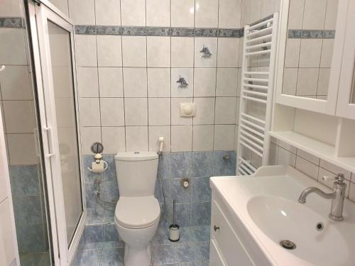 a small bathroom with a toilet and a sink at Kavouri Seaside 85sqm Apartment 5' from the beach in Athens