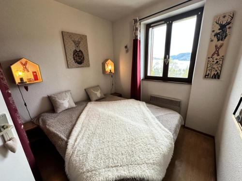 ein kleines Schlafzimmer mit einem Bett und einem Fenster in der Unterkunft Résidence Le Grand Adret - 2 Pièces pour 4 Personnes 024 in Villard-de-Lans