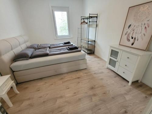 a bedroom with a bed and a dresser in it at Ferienwohnung und Monteurzimmer in Albstadt