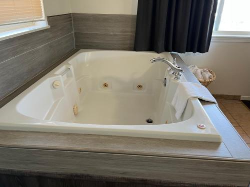 a white bath tub with a faucet in a bathroom at Port Townsend Inn in Port Townsend