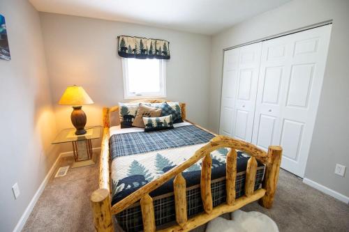 a bedroom with a wooden bed and a window at 3 Bedroom Family Friendly Home in Anchorage