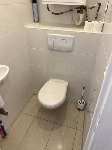 a small bathroom with a toilet and a sink at T2 Colombes proche toutes commodités in Colombes
