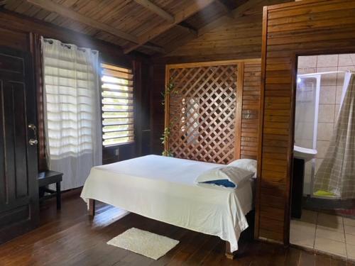 a bedroom with a white bed in a room at LOTO'S House in West End