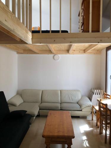 a living room with a couch and a table at CASTILLO CARAVACA PRINCIPAL in Caravaca de la Cruz