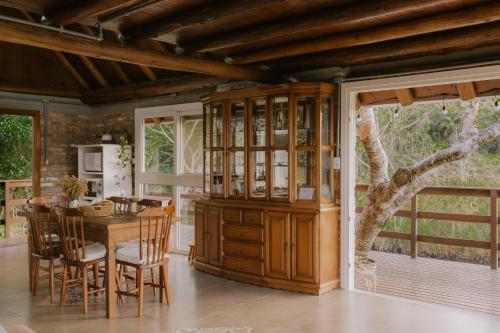 a kitchen with a table and chairs and a dining room at Chalé Deckmont in Caraa