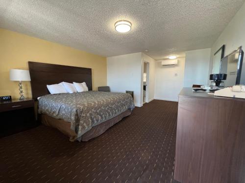 a hotel room with a bed and a sink at Port Townsend Inn in Port Townsend