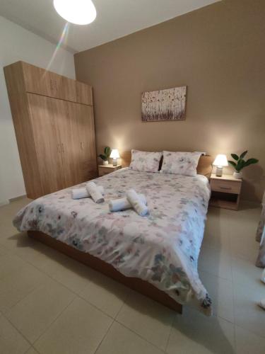 a bedroom with a large bed with two pillows at Kritharia Guesthouse Volos in Kritharia